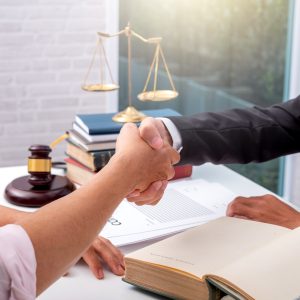 Businessman shaking hands to seal a deal with his partner lawyers or attorney
