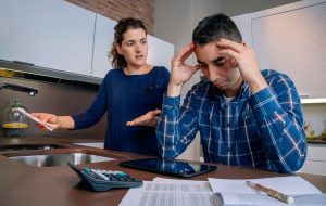 Desperate young couple with debts reviewing their bills